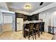 Basement wet bar with granite countertop and dark wood cabinets at 340 Kincardine Way, Alpharetta, GA 30022