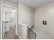 Hallway view featuring a staircase, a laundry room and neutral paint throughout at 3008 Pine Tree Trl # 16D, South Fulton, GA 30349