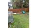 Small backyard with wooden fence and green grass at 255 Thornbush Ln, Lawrenceville, GA 30046