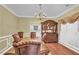 Elegant dining room with a large wooden table, chandelier, and built-in hutch at 255 Thornbush Ln, Lawrenceville, GA 30046