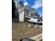 Two-story house with a brown roof, light stucco, brown trim, and an attached garage at 255 Thornbush Ln, Lawrenceville, GA 30046