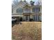 Front view of a two-story house with beige siding and a balcony at 255 Thornbush Ln, Lawrenceville, GA 30046