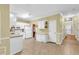 Kitchen with white cabinets and tile floors, open to entryway at 255 Thornbush Ln, Lawrenceville, GA 30046