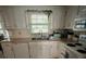 Kitchen features white cabinets and a double sink at 255 Thornbush Ln, Lawrenceville, GA 30046