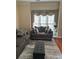 Spacious living room with gray sofa and large windows at 255 Thornbush Ln, Lawrenceville, GA 30046