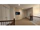 Upstairs hallway with neutral carpeting and multiple bedroom doors at 2611 Cannon Farm Ln, Duluth, GA 30097