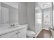 Bathroom featuring a white sink vanity, toilet, and window view at 2295 Creekview Trl, Decatur, GA 30035