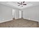 Main bedroom featuring carpet, ceiling fan, and adjoining bathroom with shower at 2295 Creekview Trl, Decatur, GA 30035