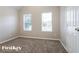 Bedroom featuring neutral walls, carpet, and two windows with blinds at 2295 Creekview Trl, Decatur, GA 30035