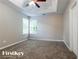 Bedroom featuring neutral walls, carpet, a tray ceiling, a ceiling fan, and a window at 2295 Creekview Trl, Decatur, GA 30035