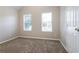 Bedroom with neutral paint, soft carpet, and two large windows at 2295 Creekview Trl, Decatur, GA 30035