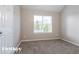 Bedroom featuring neutral walls, carpet, a window with blinds, and white trim at 2295 Creekview Trl, Decatur, GA 30035