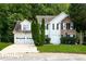 Two-story home with a two car garage, a manicured lawn and decorative evergreen shrubs at 2295 Creekview Trl, Decatur, GA 30035