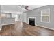 Open-concept living room with a fireplace, wood floors, and lots of natural light at 2295 Creekview Trl, Decatur, GA 30035