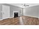 Light-filled living room featuring a fireplace, wood floors, and a ceiling fan at 2295 Creekview Trl, Decatur, GA 30035