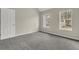 Bright bedroom with grey carpet and two windows at 3029 Oakvale Hts, Decatur, GA 30034