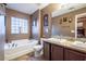 Main bathroom with double vanity, soaking tub, and tiled floor at 3363 Fernview Dr, Lawrenceville, GA 30044