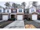 Brick front townhouse with two-car garage and landscaped yard at 3363 Fernview Dr, Lawrenceville, GA 30044