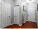 A view down a hallway with hardwood flooring and white doors at 3363 Fernview Dr, Lawrenceville, GA 30044