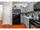 Gray cabinets, granite counters, and black appliances in kitchen at 3363 Fernview Dr, Lawrenceville, GA 30044