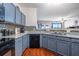 Modern kitchen with granite countertops and gray cabinets at 3363 Fernview Dr, Lawrenceville, GA 30044