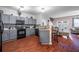 Modern kitchen with gray cabinets, granite counters, and black appliances at 3363 Fernview Dr, Lawrenceville, GA 30044