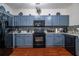 Gray kitchen cabinets, granite countertops and black appliances at 3363 Fernview Dr, Lawrenceville, GA 30044