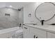 Modern bathroom with gray tile, white vanity, and a black faucet at 514 Dogwood Cir, Norcross, GA 30071