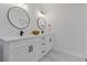 Double vanity bathroom with white cabinets and marble countertop at 514 Dogwood Cir, Norcross, GA 30071