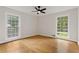 Bright bedroom with hardwood floors and two large windows at 514 Dogwood Cir, Norcross, GA 30071