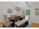 Bright dining room with a wood table, bench seating, and access to a deck at 514 Dogwood Cir, Norcross, GA 30071