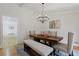 Bright dining room with chandelier and view into kitchen at 514 Dogwood Cir, Norcross, GA 30071