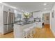 Modern kitchen featuring white cabinets, granite island, and stainless steel appliances at 514 Dogwood Cir, Norcross, GA 30071