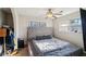 Cozy bedroom with a gray tufted headboard and a ceiling fan at 7034 Capps Ferry Rd, Douglasville, GA 30135