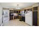 Traditional kitchen with tile flooring, black appliances, and dark cabinetry at 7034 Capps Ferry Rd, Douglasville, GA 30135