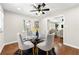 Bright dining room with hardwood floors and a glass-top dining table at 2692 Cocklebur Rd, Decatur, GA 30034