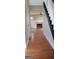 Inviting hallway with hardwood floors leading to a spacious living area with fireplace and abundant natural light at 520 Millbrook Village Dr, Tyrone, GA 30290
