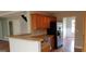 Open-concept kitchen featuring a breakfast bar, stainless steel appliances, and seamless access to the dining area at 520 Millbrook Village Dr, Tyrone, GA 30290