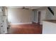 Spacious living room with hardwood floors, a fireplace, and direct access to the adjacent kitchen and dining areas at 520 Millbrook Village Dr, Tyrone, GA 30290