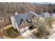 Aerial shot of home's front, including yard, driveway, roof, and garage at 6834 Fireside Ln, South Fulton, GA 30349