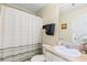 Neutral bathroom featuring a shower-tub combination with updated fixtures and hardware at 6834 Fireside Ln, South Fulton, GA 30349