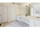 Bright bathroom featuring a double sink vanity, white cabinetry, and ample counter space at 6834 Fireside Ln, South Fulton, GA 30349