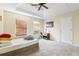 Spacious bedroom featuring a tray ceiling, plush carpeting, natural light and neutral-colored walls at 6834 Fireside Ln, South Fulton, GA 30349