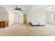 Large primary bedroom with carpet, ceiling fan, and natural light with space for a seating area or desk at 6834 Fireside Ln, South Fulton, GA 30349