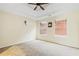 Carpeted bedroom showcasing a tray ceiling, dual windows with blinds, and ample natural light at 6834 Fireside Ln, South Fulton, GA 30349