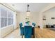 Bright dining area featuring a modern chandelier, hardwood floors, and large window with natural light at 6834 Fireside Ln, South Fulton, GA 30349