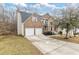 Two-story brick home with a two-car garage and manicured lawn at 6834 Fireside Ln, South Fulton, GA 30349