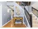 Foyer with hardwood floors, staircase, and an ornate console table at 6834 Fireside Ln, South Fulton, GA 30349