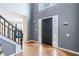 Foyer boasts hardwood floors, a tall ceiling, and a grand staircase at 6834 Fireside Ln, South Fulton, GA 30349