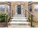 Close-up of a home's front entrance with brick facade and landscaped yard at 6834 Fireside Ln, South Fulton, GA 30349